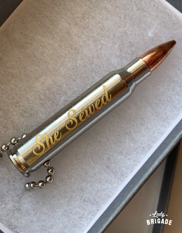 Image of 223 Bullet with script font "She Served" Engraved on it.