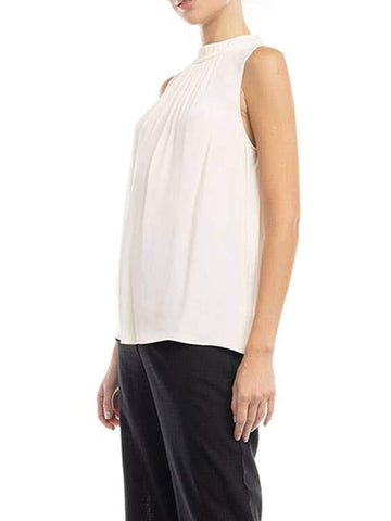 side-view of woman wearing a sleeveless viscous blouse in white color
