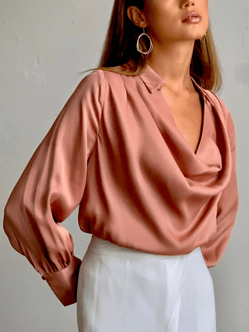 model wearing a rose coloredlong-sleeved blouse