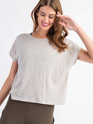 Woman modeling an oatmeal colored yoga top